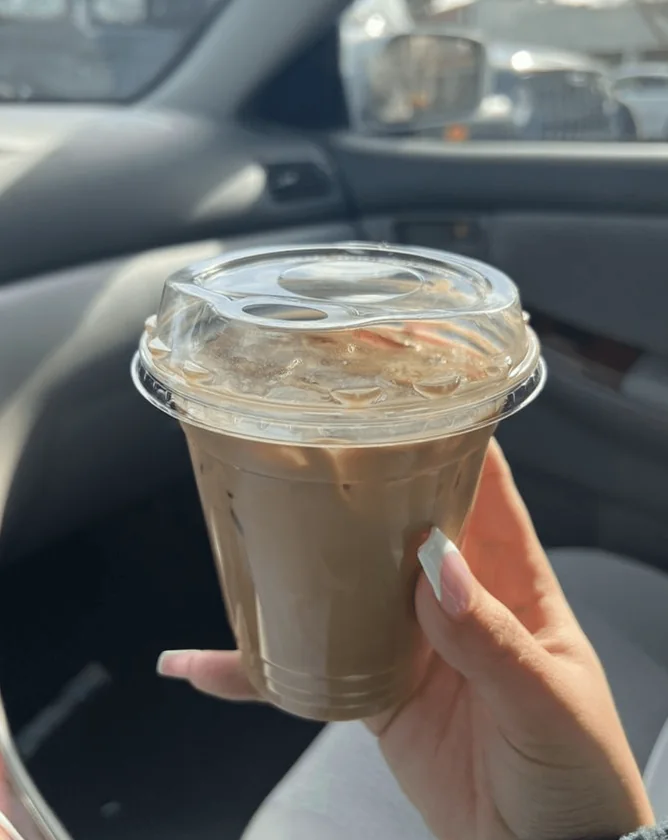 An iced coffee drink held in a hand