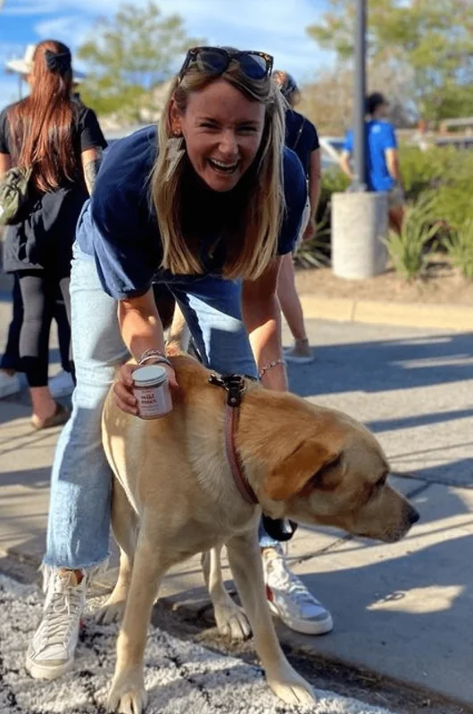 Community members with a friendly dog outside the cafe