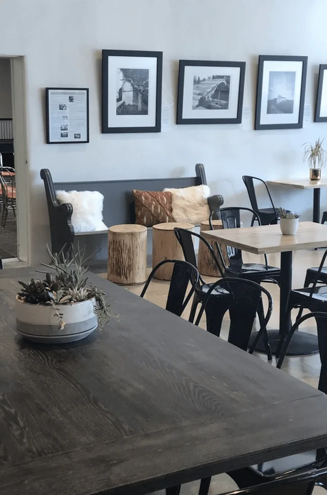 Seating area with tables and framed prints